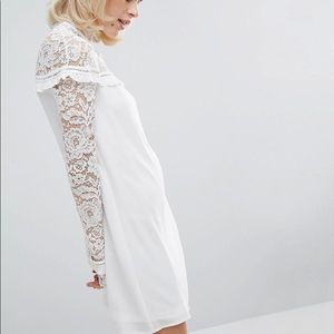 Lace panels if the dress with ruffle detail.